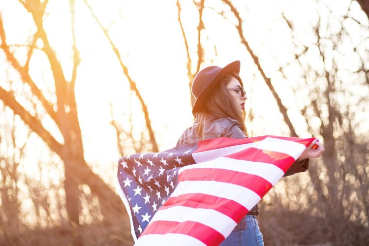 Girl is waving american flag
